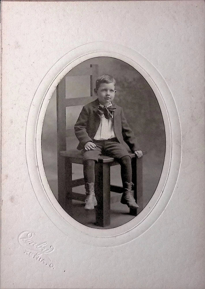 Antique Board Photograph Boy Sitting on Chair Oval Mat Embossed Photographer Model
