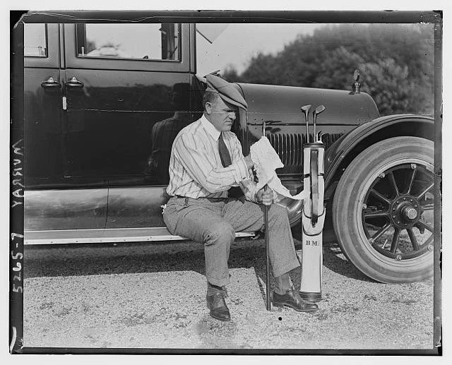 Photo:Billy Murray 1910s Seated on Car Running Board Polishing Golf Clubs Model