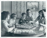 Press Photo American Family Playing Monopoly Board Game at Table 1970s Model