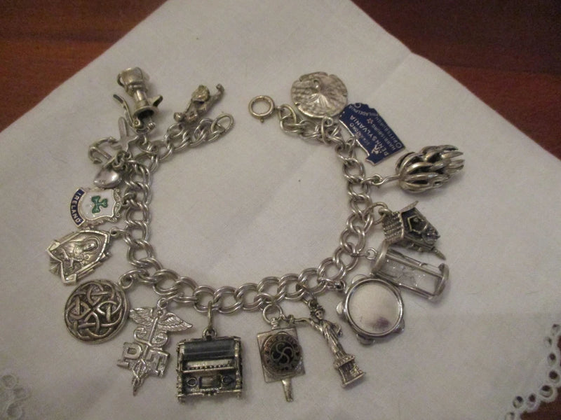 Vintage sterling silver 50's 60's CHARM bracelet,  16 charms, 7", 45 gm Charms