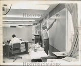 1968 Press Photo Gil Clark and worker painting board at Hurricane Center, Miami Model
