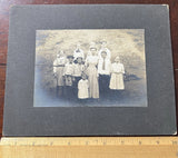 Photo on Board 9 Children and Woman Hats,Bows,Bowties, Couple moved during photo Model