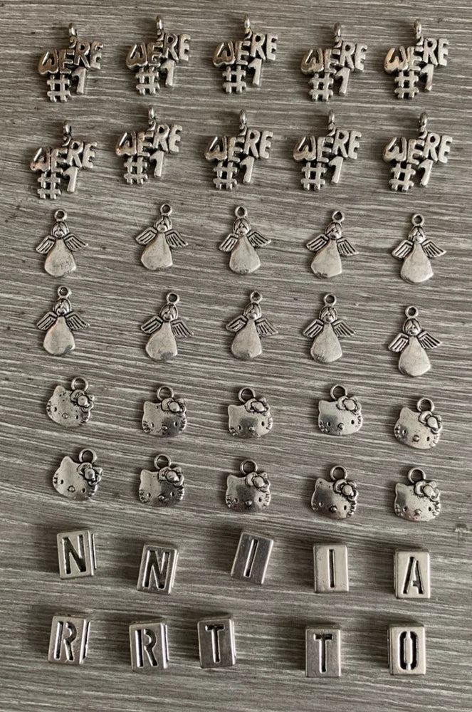 BRACELET CHARMS. THIS IS A SEKECTION OF 40 SMALL SILVER COLOURED CHARMS Charms