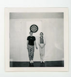 Odd rigid pose by dart board -   vintage snapshot found photo Model