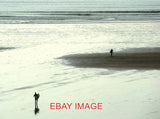 PHOTO  SURFERS AT SAUNTON SANDS SURFERS STEP OUT WITH THEIR BOARDS TO REACH THE Model
