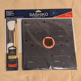 Sashiko starter kit with fabric, templates, thread, fabric pencil, and needles. Model