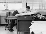 Draughtsman working closely a drawing board, leaning over board wh Old Photo Model