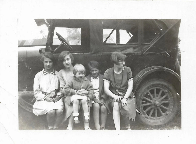 antique photo girls sitting on antique car running board girl glasses looks away Model