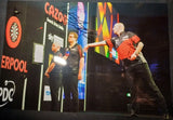 nathan aspinall throws a dart at the board during his match signed 12x8 photo Model