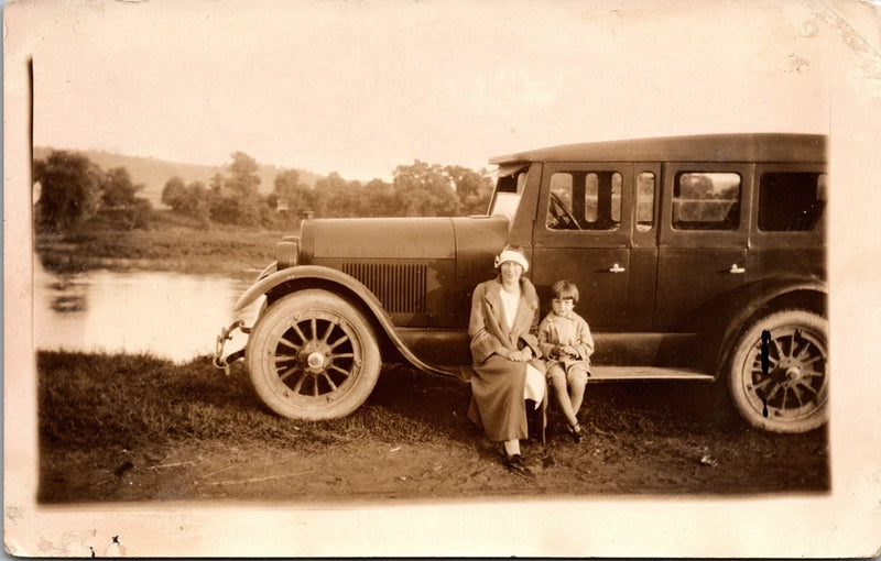 Postcard Real Photo RPPC Woman and Child Sitting on Running Board of Automobile Model