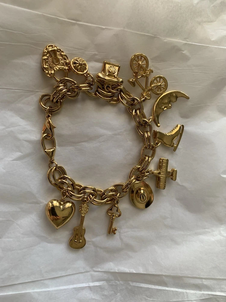 Vtg Charm Bracelet Gold Tone 9 Charms Cowboy Hat Airplane Lock Key Skate Phone Charms