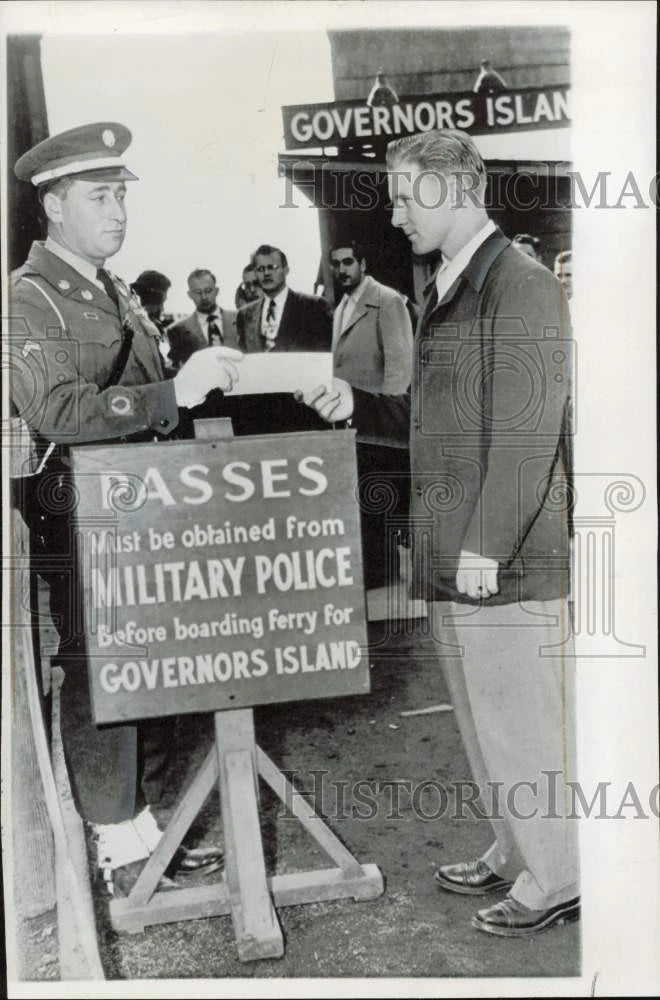Press Photo Passenger presents pass to board ferry for Governors Island Model