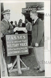 Press Photo Passenger presents pass to board ferry for Governors Island Model