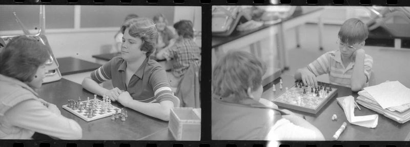 Negative photo strip school boys girls playing chess board game boy mouth taped Model