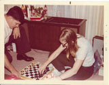 vintage color photo girl man playing chess board game on the floor Model