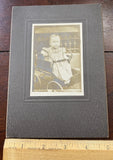 Photo on Board, Young Child in a large wheeled Stroller. Model