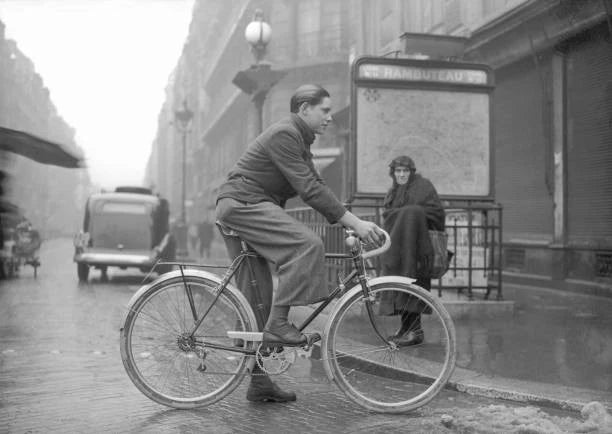 This bicyclist who replaced his wheels with wood boards stands bef- Old Photo Model