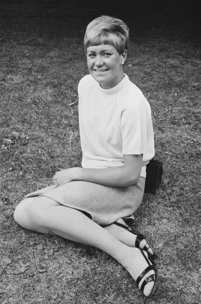 British athlete Lillian Board sits on the ground wearing casual cl- Old Photo Model