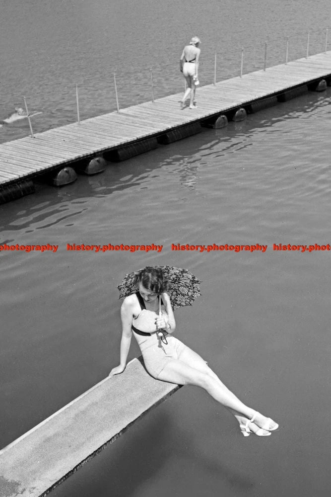 F000498 A young woman with an umbrella sitting on the diving board BdM Germany 1 Model